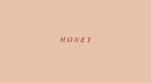 a pink background with the word honey written in red letters .