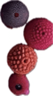 three different colored balls are stacked on top of each other .