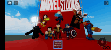 a group of cartoon characters are standing in front of a sign for marvel studios