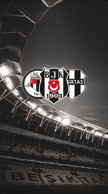 a black and white photo of a stadium with the logos for bjk 1903