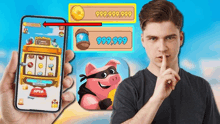 a man is holding a cell phone in front of a slot machine with a pink pig on it .