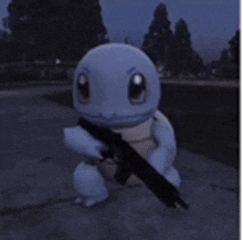 a squirtle from pokemon is holding a gun in its hands .