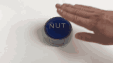 a person is pressing a nut button with their finger