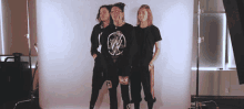 three people are standing in front of a white backdrop and one of them is wearing a shirt that says rncs