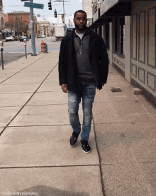 a man walking down a sidewalk in front of a building with a green sign that says ' washington st ' on it