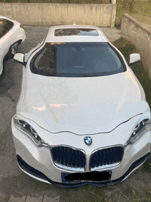 a white bmw car with a license plate that says erhan