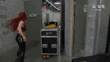 a woman stands in front of a door that has a sign on it that says ' wrestling only '