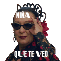 a woman wearing sunglasses has the word niña on her head