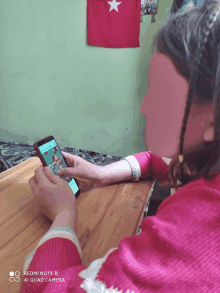 a girl is using a redmi note 8 phone