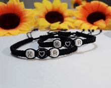 a pair of bracelets with the initials k and r on them