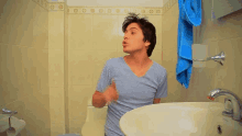 a man giving a thumbs up in a bathroom