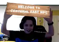 a young boy wearing headphones is holding a sign that says welcome to central east rpc