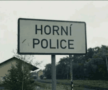 a white sign that says horni police in black letters