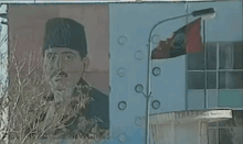 a painting of a man with a mustache and a hat on a wall