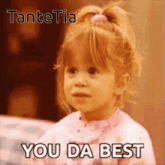 a little girl with a ponytail is saying you da best