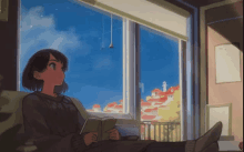 a girl sits on a couch reading a book in front of a window