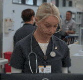 a nurse with a stethoscope around her neck and a name tag that says ' a. ' on it