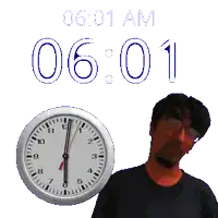 a man stands in front of a clock that reads 6:01