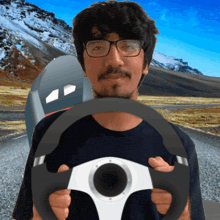 a man with glasses is holding a steering wheel in front of a mailbox