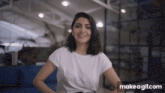 a woman in a white t-shirt is smiling in front of a make a gif.com watermark