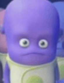 a close up of a purple baby with big eyes making a sad face .