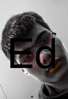 a man wearing glasses has the letter ed written on his face