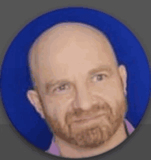 a bald man with a beard is standing in front of a blue circle .