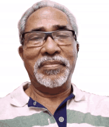 a man with glasses and a beard wearing a striped shirt