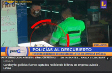 a spanish news channel shows a man signing a document