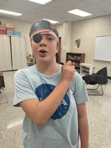 a young girl wearing a pirate hat and eye patch giving a thumbs up