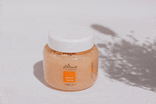 a jar of coconut creamy body scrub with a white lid