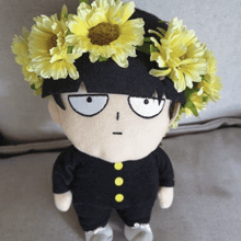 a stuffed doll with a flower crown on his head