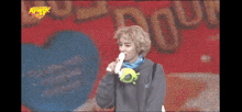 a man is eating a banana in front of a large screen