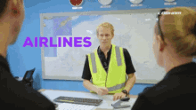 a man in a yellow vest stands in front of a group of people with the word airlines written in purple