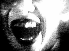 it is a black and white photo of a person 's mouth with smoke coming out of it .