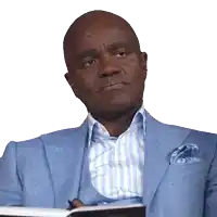 a bald man wearing a blue suit and striped shirt is holding a book
