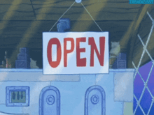 a sign that says open hangs from a rope