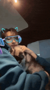 a person wearing headphones and goggles is petting a dog