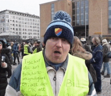 a man wearing a yellow vest that says " bill "