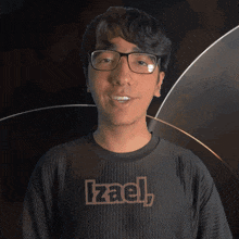 a man wearing glasses and a black shirt that says izael