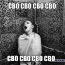 a black and white photo of a man wrapped in a blanket with the words cbo cbo cbo cbo in white letters