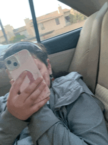 a girl in a car taking a selfie with her cell phone