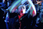 a pixelated image of a crowd of people dancing in a dark room