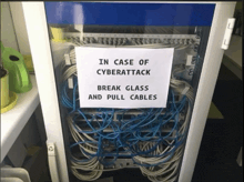a sign on a server that says in case of cyberattack break glass and pull cables