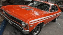 a red car is parked in a parking lot .