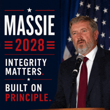 a man stands at a podium in front of a sign that says massie 2028 integrity matters and built on principle