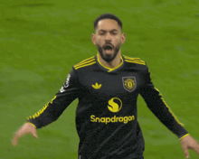 a soccer player in a black jersey with the number 10 on it