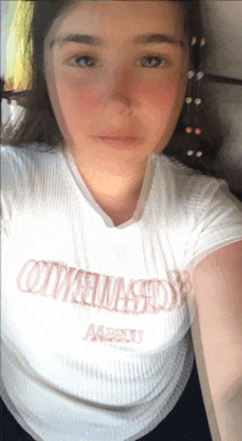 a woman wearing a white t-shirt that says ottawa on the front