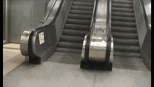 an escalator with a sign on the side that says ' emergency exit ' on it