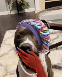 a dog wearing a headband and a pearl necklace